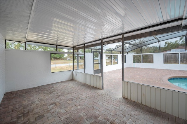 unfurnished sunroom featuring lofted ceiling