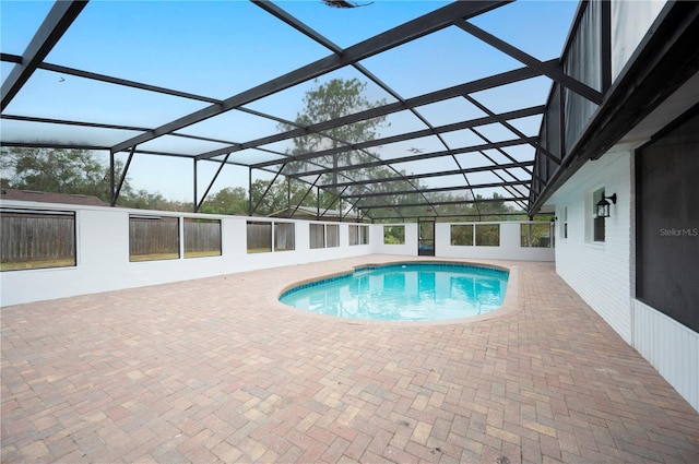 view of pool with a patio area and a lanai