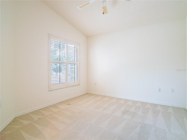 unfurnished room featuring ceiling fan, light colored carpet, and vaulted ceiling