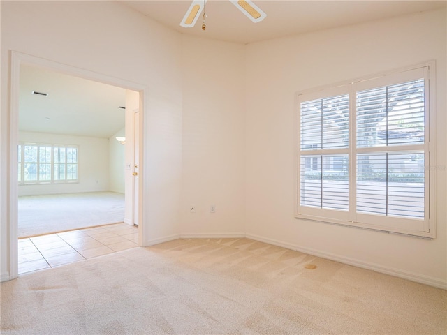 spare room with ceiling fan and light carpet