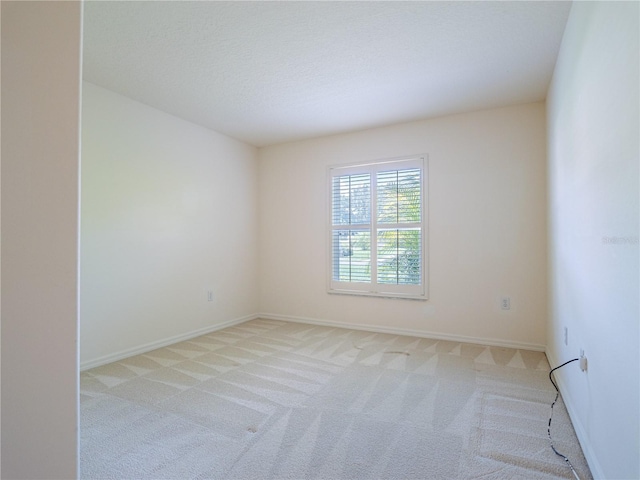 unfurnished room with light colored carpet