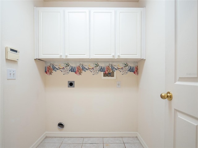 washroom featuring washer hookup, electric dryer hookup, cabinets, and light tile patterned floors