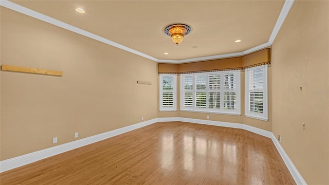 unfurnished room featuring hardwood / wood-style flooring and ornamental molding