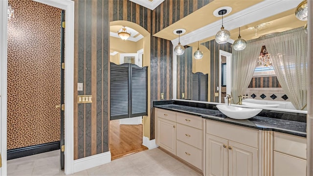 bathroom with crown molding, tile patterned floors, and vanity