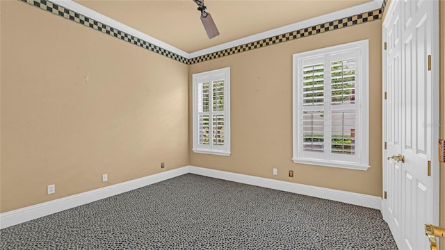 unfurnished room with ceiling fan and carpet flooring