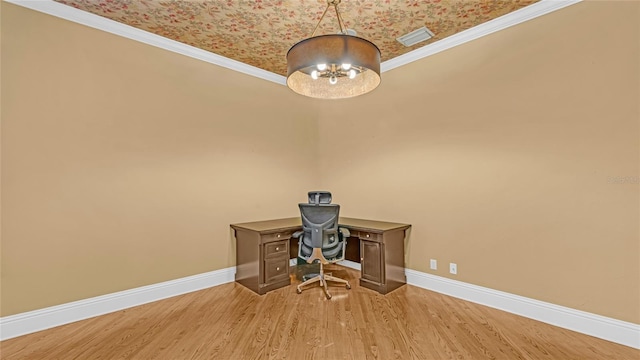 unfurnished office with hardwood / wood-style flooring, crown molding, and an inviting chandelier