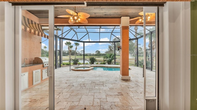 view of pool with area for grilling and sink