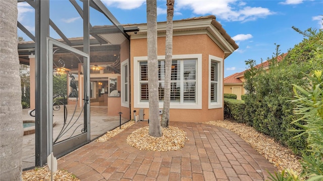 view of patio featuring a lanai