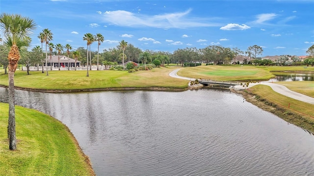 exterior space with a water view and a lawn