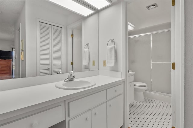 bathroom with vanity, toilet, and walk in shower