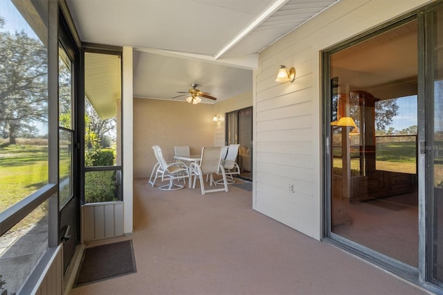 unfurnished sunroom with ceiling fan and a healthy amount of sunlight