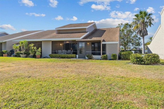 view of front facade featuring a front lawn and a sunroom