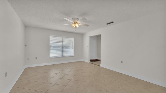 tiled spare room featuring ceiling fan and a textured ceiling