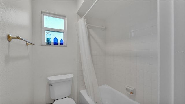 bathroom featuring shower / bath combo and toilet