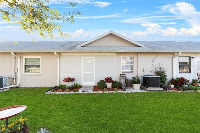 back of house with a yard, cooling unit, and a sunroom