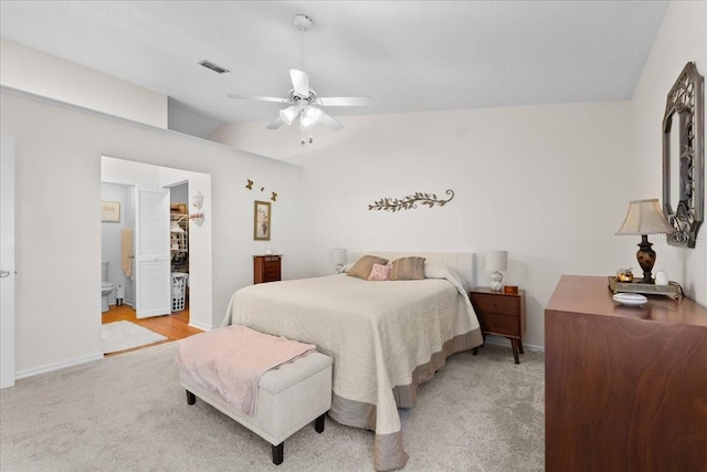 bedroom with light colored carpet, ceiling fan, a spacious closet, a closet, and lofted ceiling