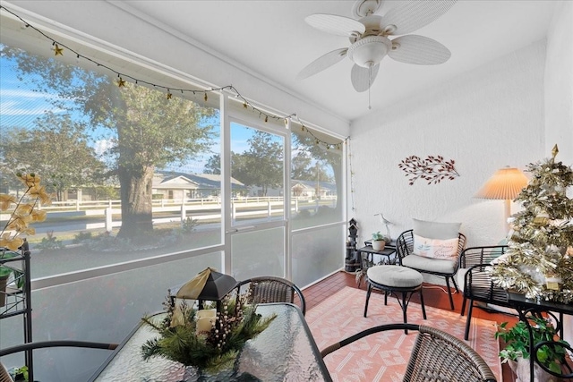 sunroom featuring ceiling fan