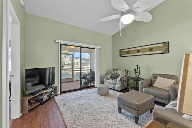 living room with ceiling fan, vaulted ceiling, and hardwood / wood-style flooring