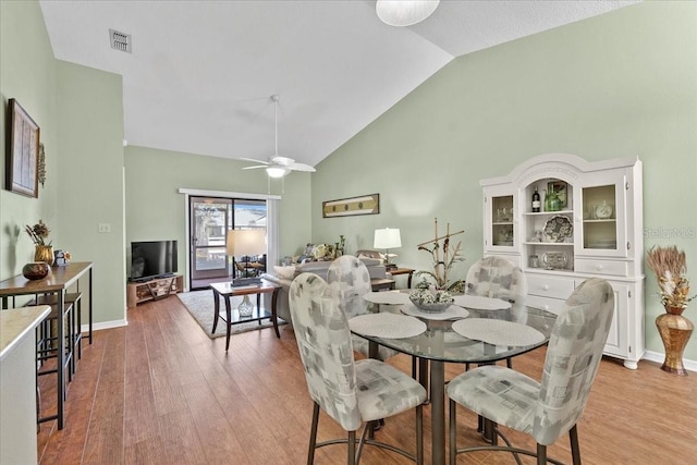 dining area with vaulted ceiling, light hardwood / wood-style flooring, and ceiling fan