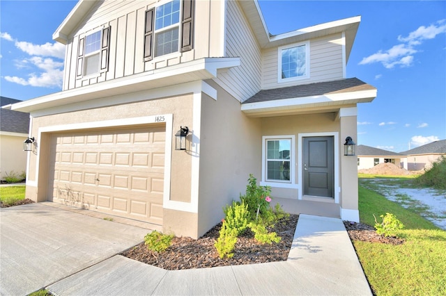 view of front of property with a front yard and a garage