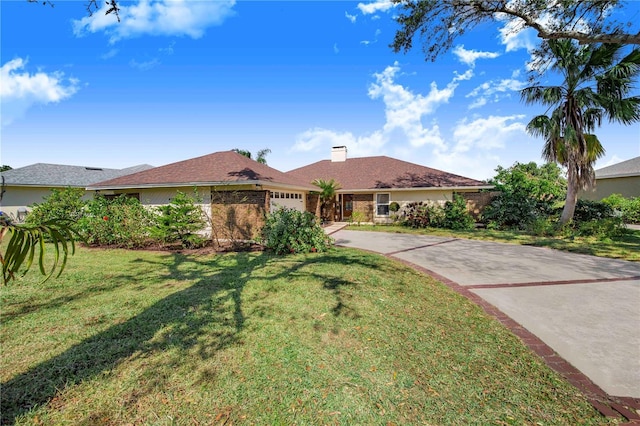 single story home with a garage and a front lawn