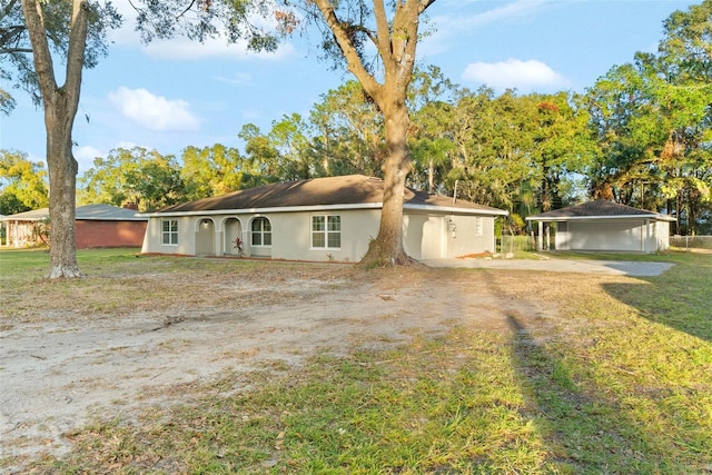 ranch-style home with a front lawn