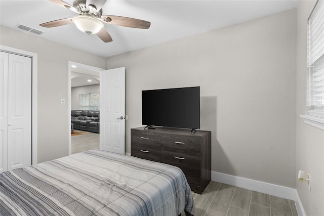 bedroom with ceiling fan, a closet, and light hardwood / wood-style flooring