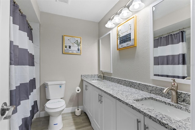 bathroom featuring hardwood / wood-style floors, vanity, toilet, and curtained shower