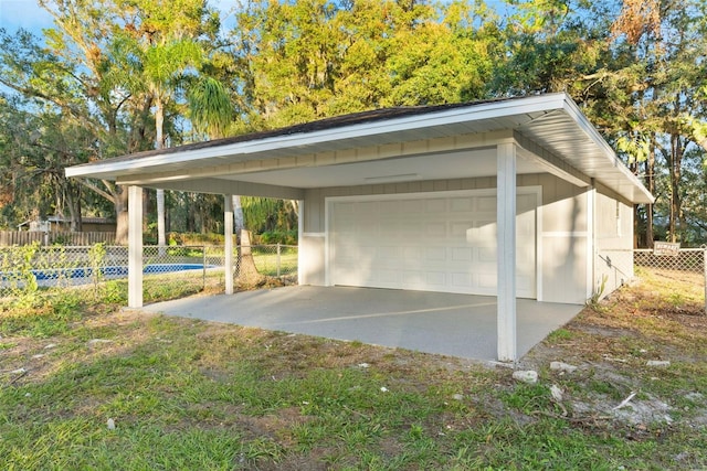 view of car parking featuring a carport and a garage