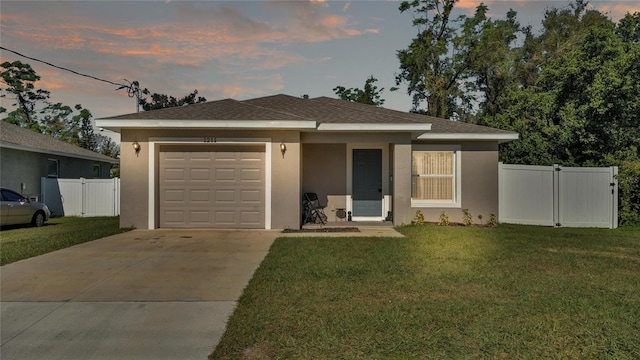 view of front facade featuring a yard and a garage