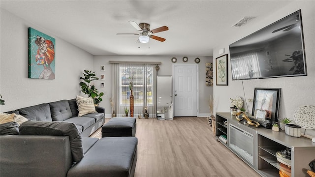 living room featuring ceiling fan and light hardwood / wood-style floors