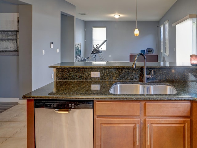 1918 Wind Meadows Dr, Bartow, FL 33830 - kitchen featuring dishwasher, dark stone countertops, light tile patterned flooring, hanging light fixtures, and brown cabinetry