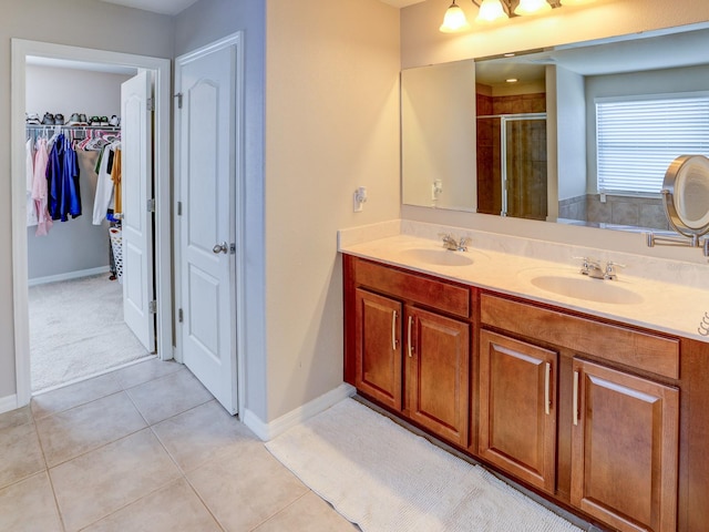 bathroom featuring tile patterned flooring, vanity, and an enclosed shower