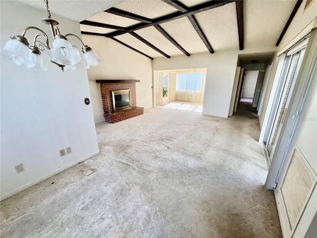 unfurnished living room featuring a brick fireplace, lofted ceiling with beams, a textured ceiling, and an inviting chandelier