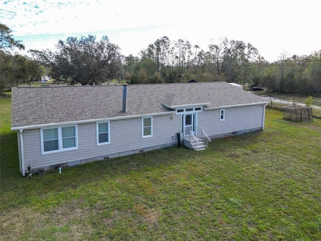 rear view of house featuring a yard