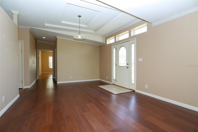 foyer entrance with dark hardwood / wood-style flooring, a tray ceiling, and crown molding