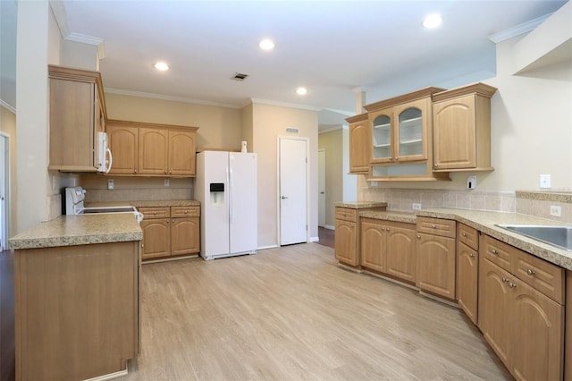 kitchen with crown molding, backsplash, white appliances, and light hardwood / wood-style flooring