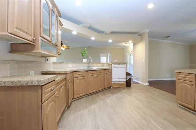 kitchen featuring crown molding, dishwasher, sink, and light hardwood / wood-style flooring