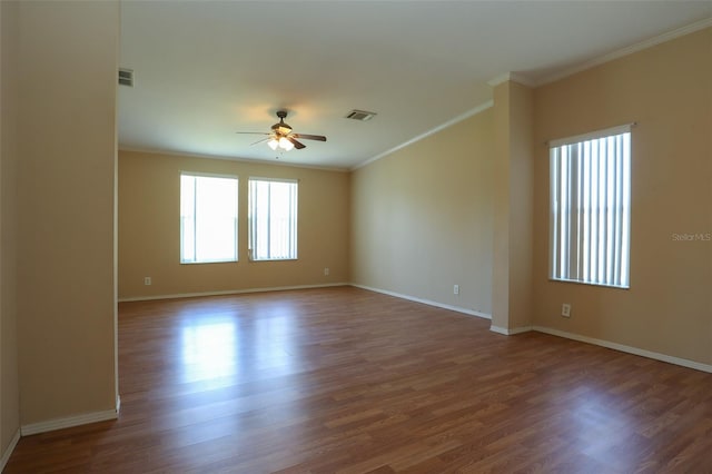 spare room with crown molding, dark hardwood / wood-style floors, and ceiling fan