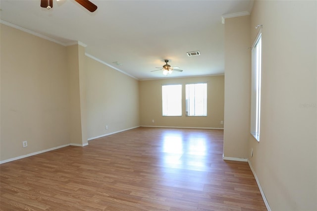 empty room with crown molding, ceiling fan, and light hardwood / wood-style floors