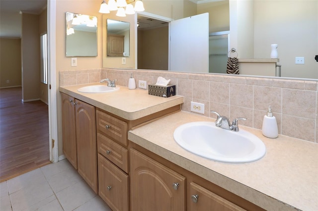 bathroom with tile patterned flooring, vanity, and decorative backsplash