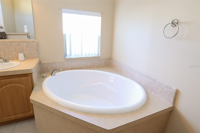 bathroom featuring vanity, a tub to relax in, and tile patterned flooring