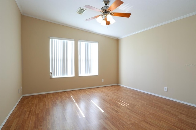 empty room featuring ornamental molding, hardwood / wood-style floors, and ceiling fan