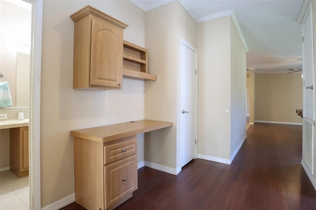 hallway with dark hardwood / wood-style flooring and crown molding