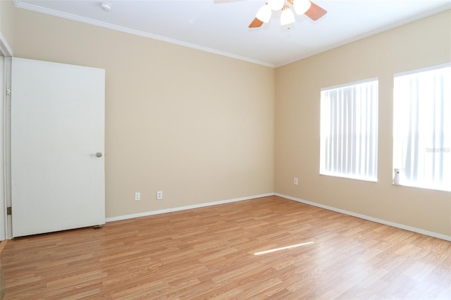 spare room featuring ceiling fan, ornamental molding, and light wood-type flooring