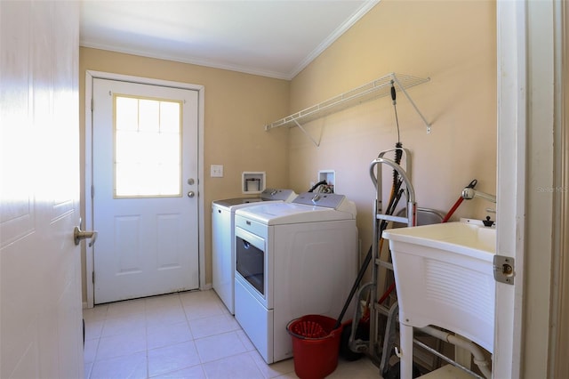 clothes washing area with washing machine and dryer, sink, light tile patterned floors, and ornamental molding