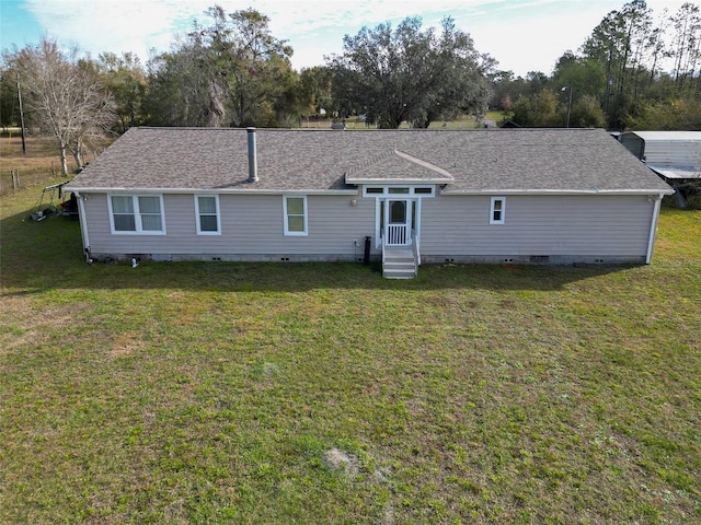 rear view of property featuring a yard