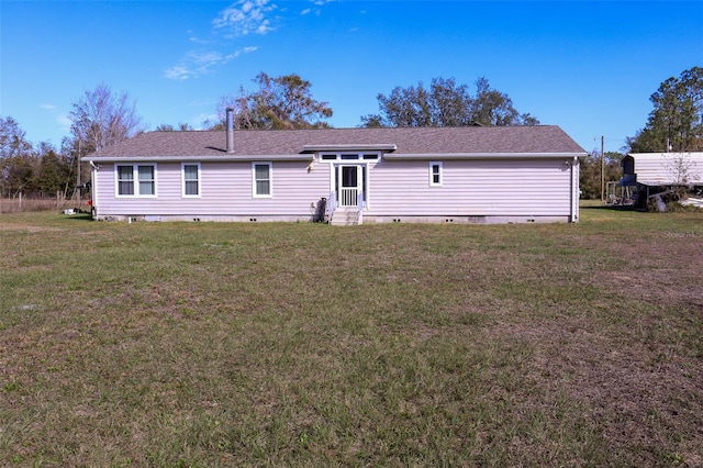 rear view of house with a yard