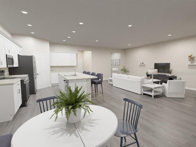 dining space with light hardwood / wood-style flooring and sink