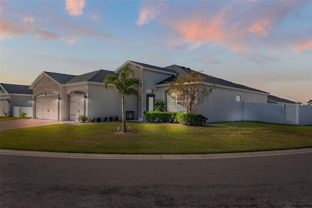 view of front of house with a garage and a yard